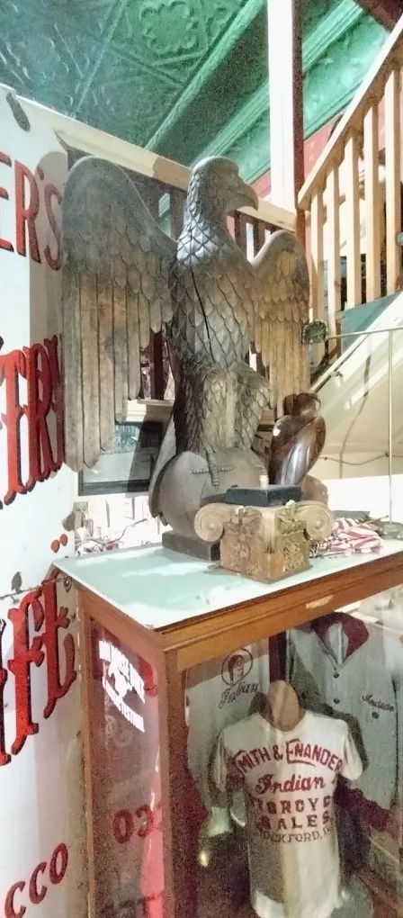 Hand-carved eagle above the vintage apparel display case