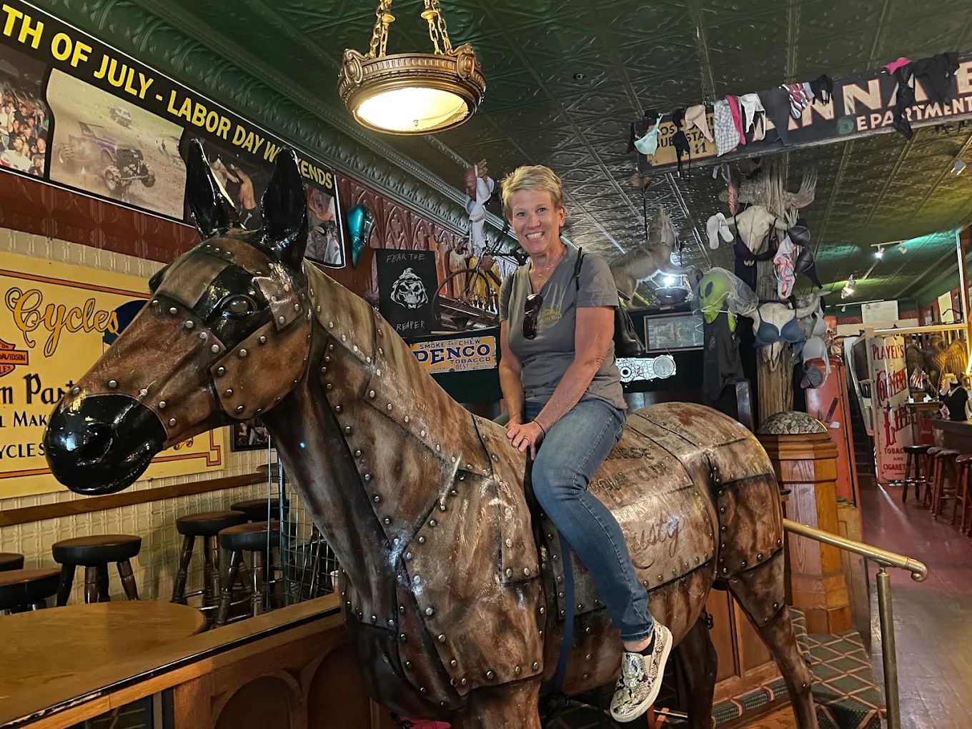 A visitor sitting on the metal horse